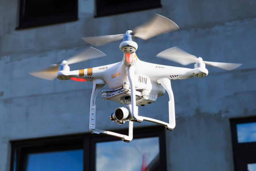 Drone flying with a camera capturing video footage