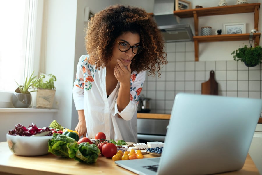 business woman in kitchen on laptop