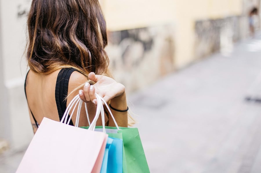 Woman holding shopping bags - hybrid shopping