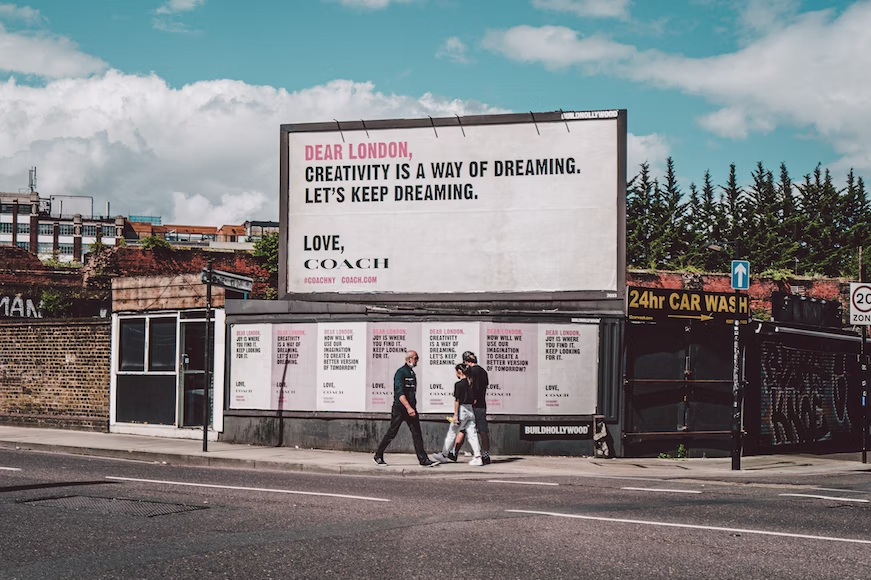 Billboard on the side of the street advertising a fashion brand - outbound marketing - Shift4Shop