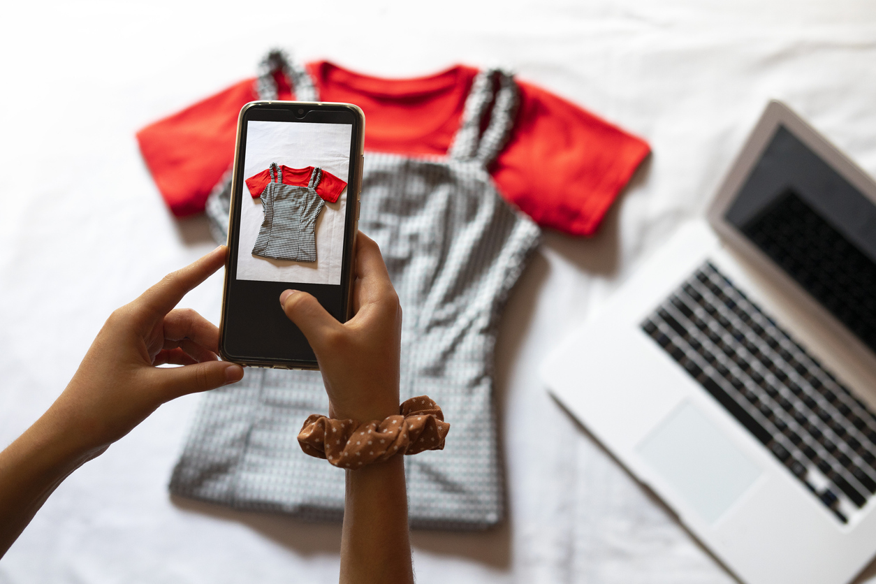 Woman taking a photo of clothing to sell online