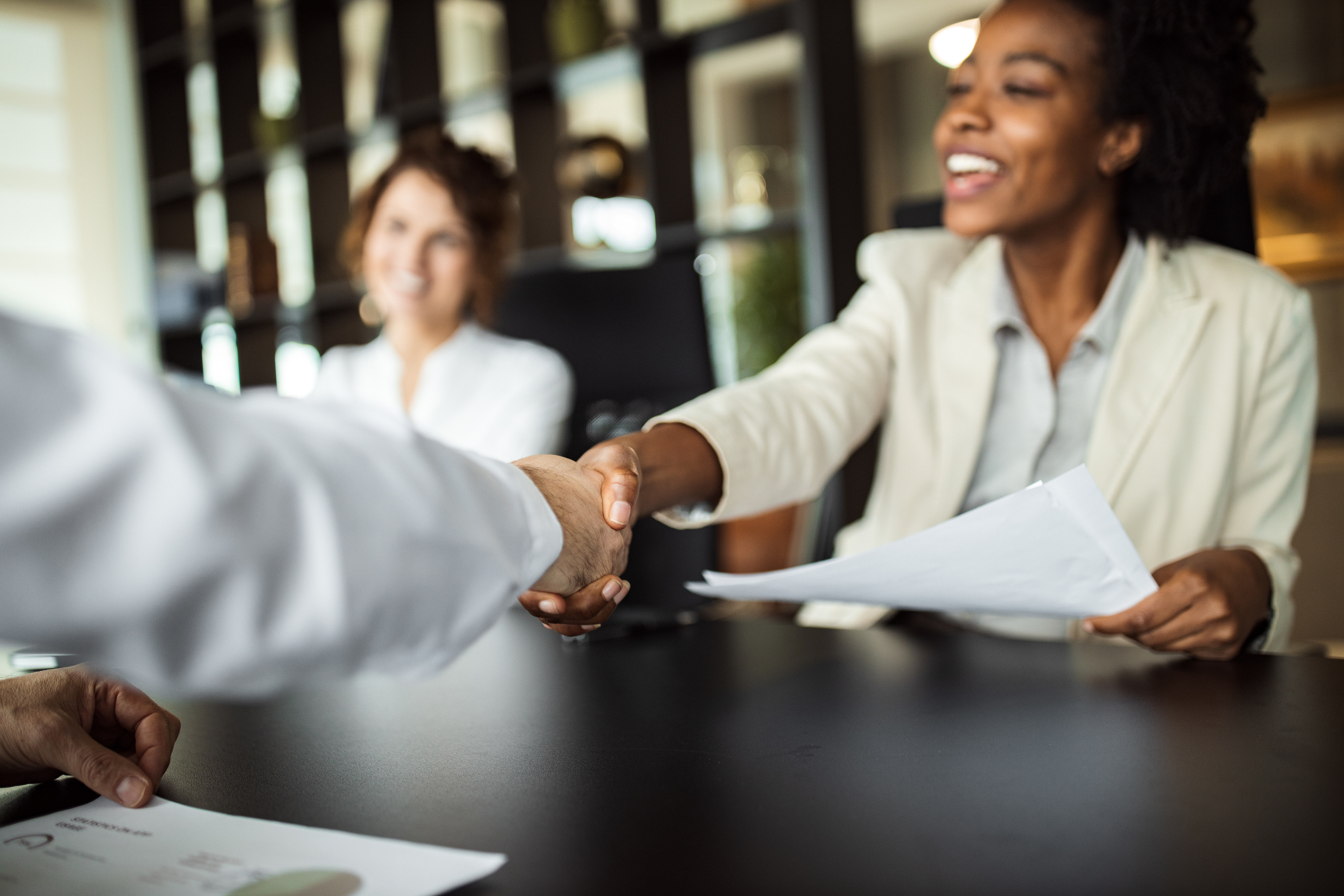 Woman shaking hands with a customer