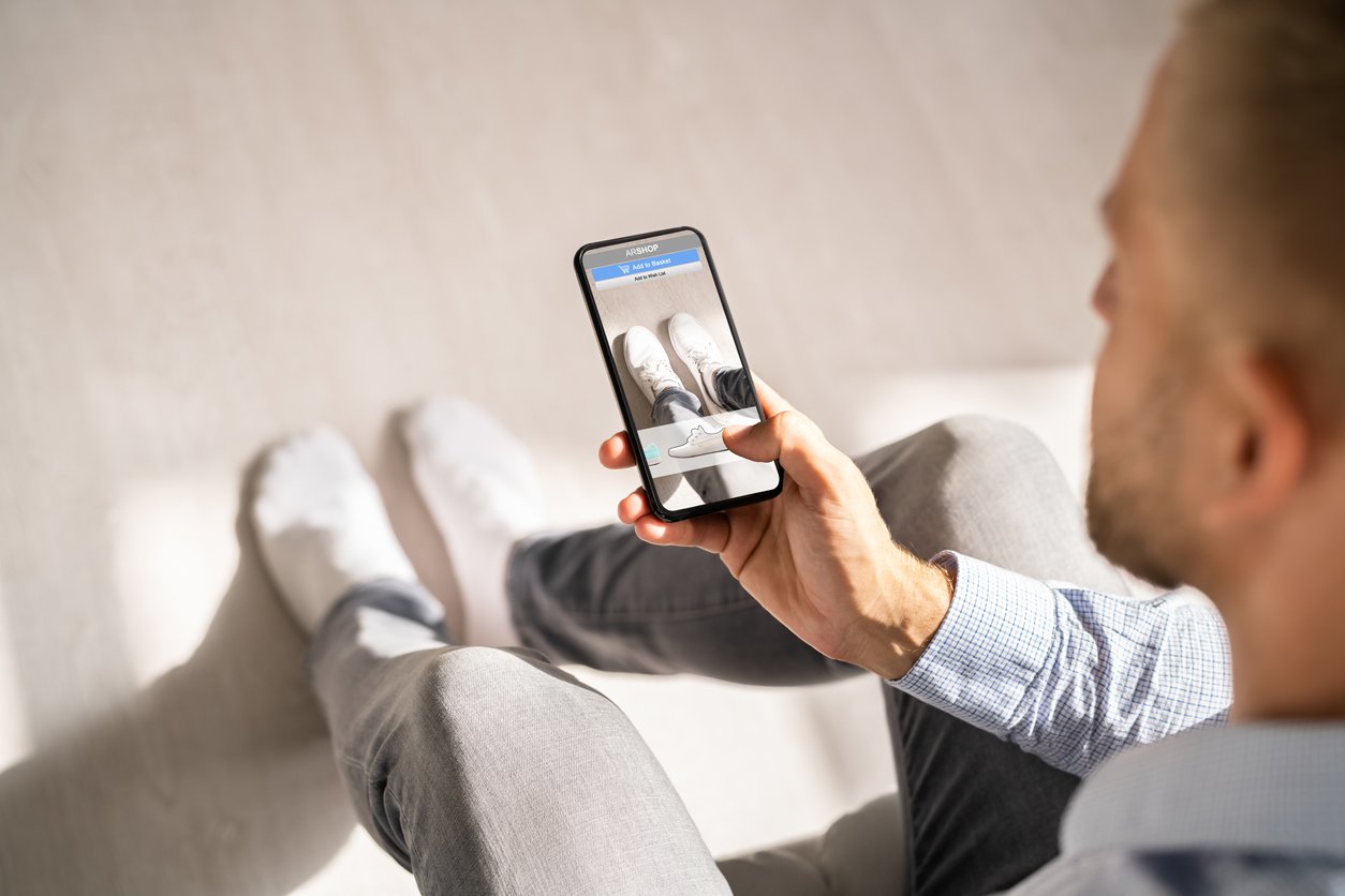 Man using AR technology to try on virtual shoes sold by an eCommerce store