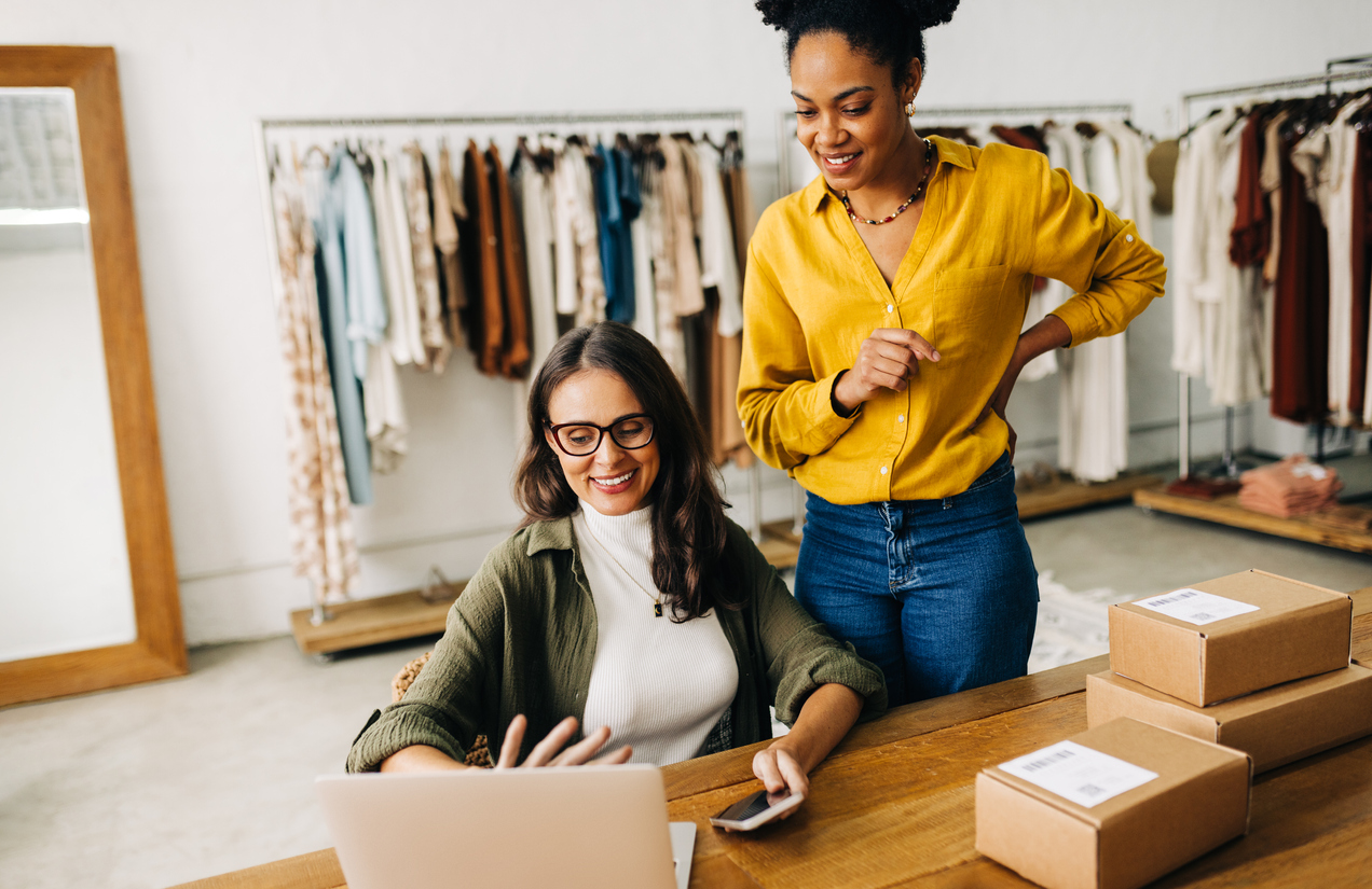 Two female eCommerce business owners streamlining their sales process on a laptop