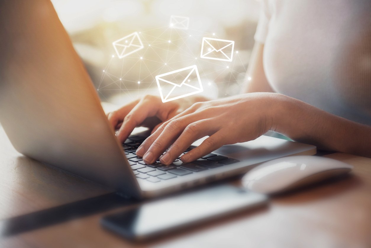 Woman using AI in email marketing | Shift4Shop